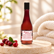Keyano Cranberry Massage Oil — styled product photo; decorative props not included.